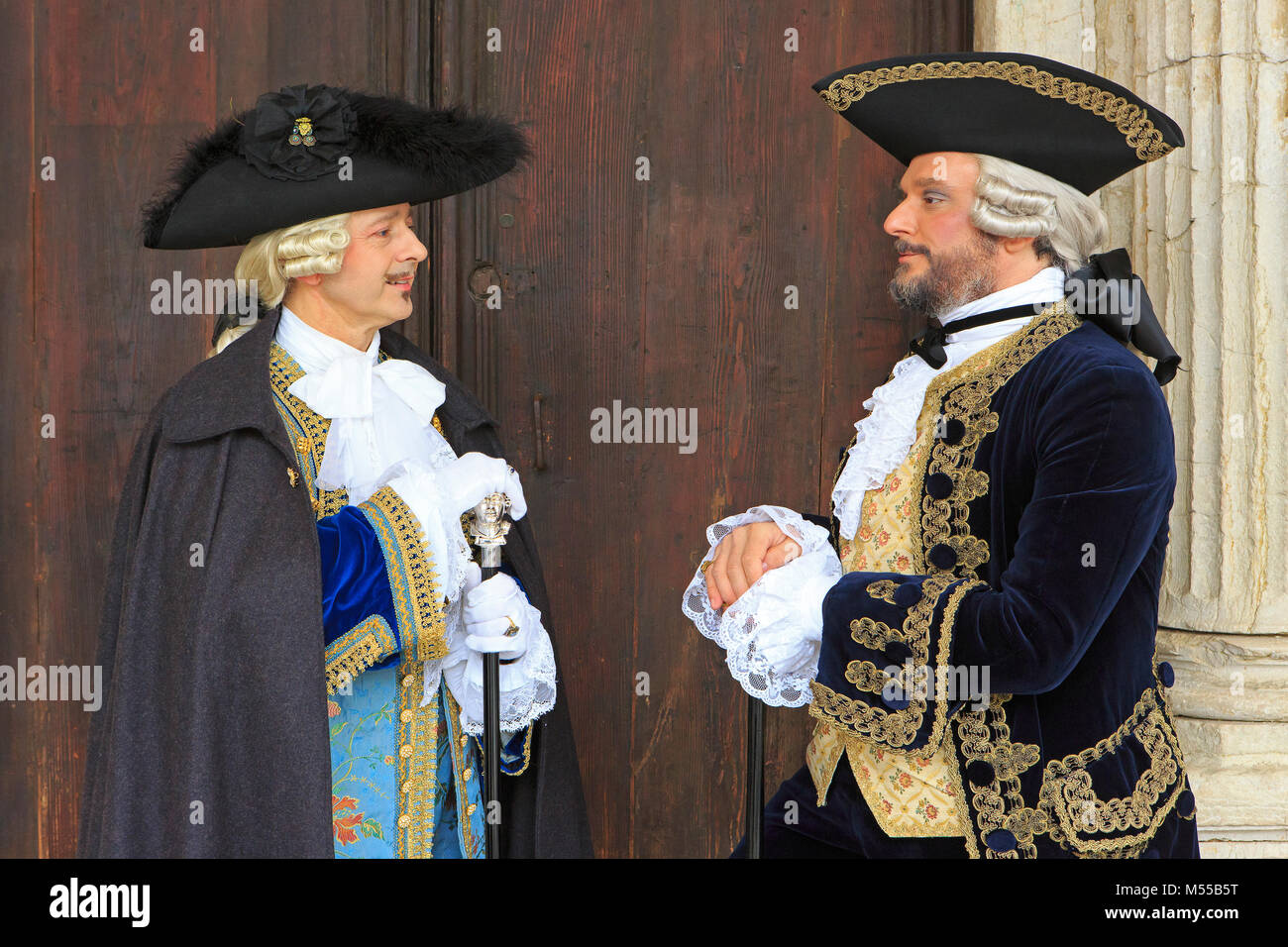 Two gentlemen in 18th-century attire outside the Doge's Palace during the Carnival of Venice (Carnevale di Venezia) in Venice, Italy Stock Photo