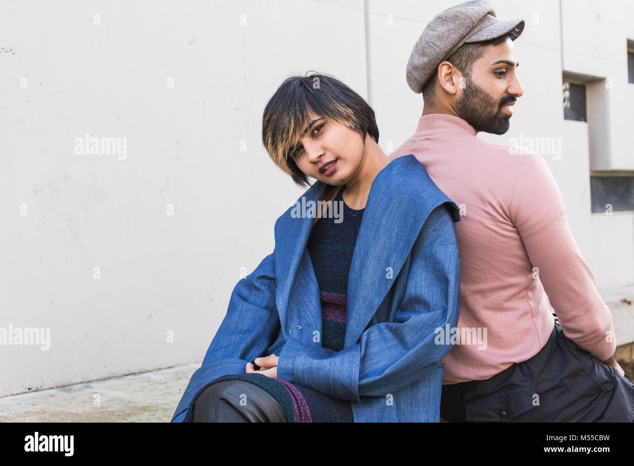 Beautiful Indian couple posing in an urban context. Street fashion and style. Stock Photo