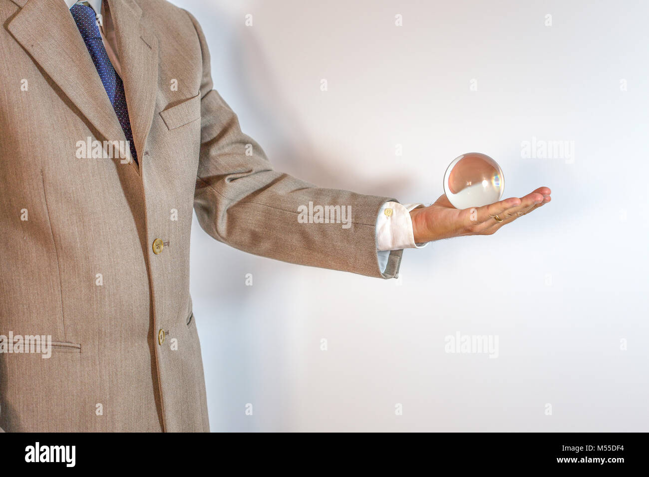 Businessman holding a crystal ball isolated on white background Stock ...