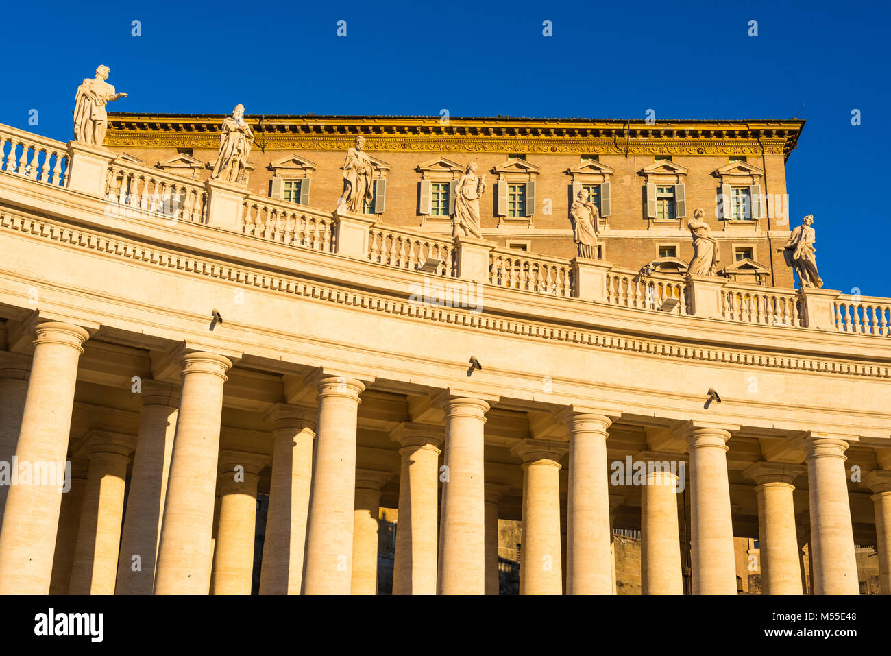 Vatican palace, residence of the Pope and statues in early morning seen from St Peter's Square. Rome. Lazio, Italy. Stock Photo