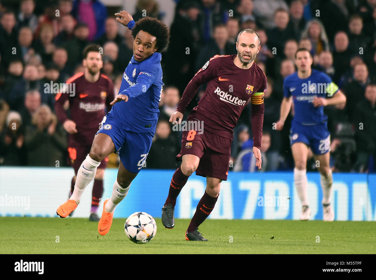 London, UK. 20th Feb, 2018. Willian of Chelsea and Andres Iniesta of Barcelona challenge for the ball during the UEFA Champions League Round of 16 first leg match between Chelsea and Barcelona at Stamford Bridge on February 20th 2018 in London, England. Credit: PHC Images/Alamy Live News Stock Photo