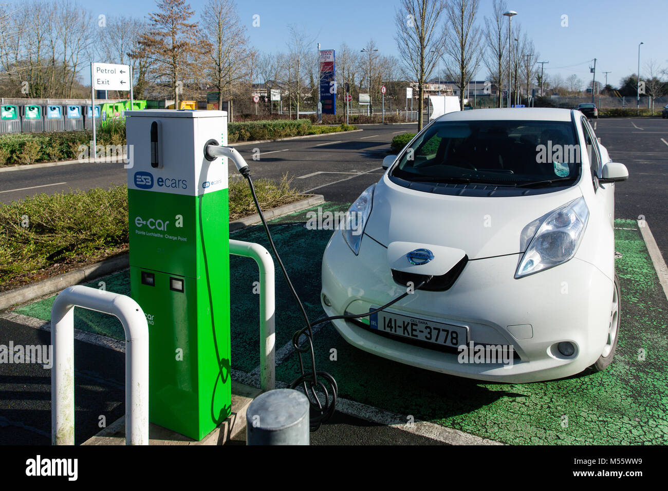 Maynooth, County Kildare, Ireland. 20 Feb 2018: Electric vehicle Ecar Nissan Note being charged at the ESB charging point. Charging car battery becoming more and more accessible with increasing number of charge stations now easily found on-street, shopping centres and car parks. Stock Photo