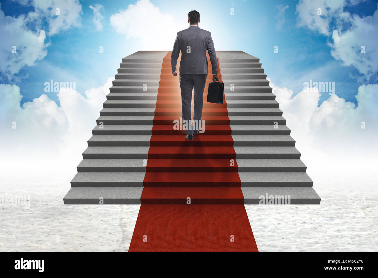 Young businessman climbing stairs and red carpet into sky Stock Photo ...