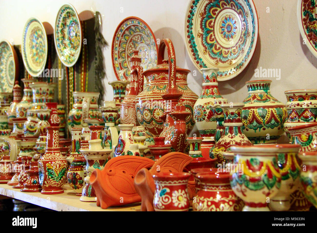 earthenware on the shelves of pottery shop Stock Photo - Alamy