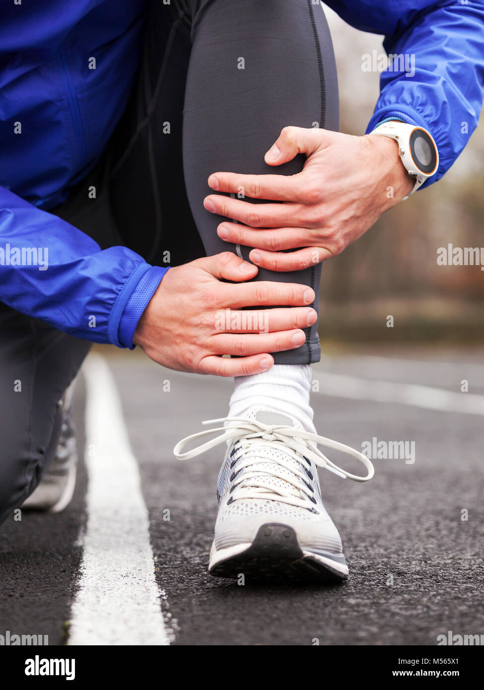 Cropped shot of a young runner holding his leg in pain. Shin splints