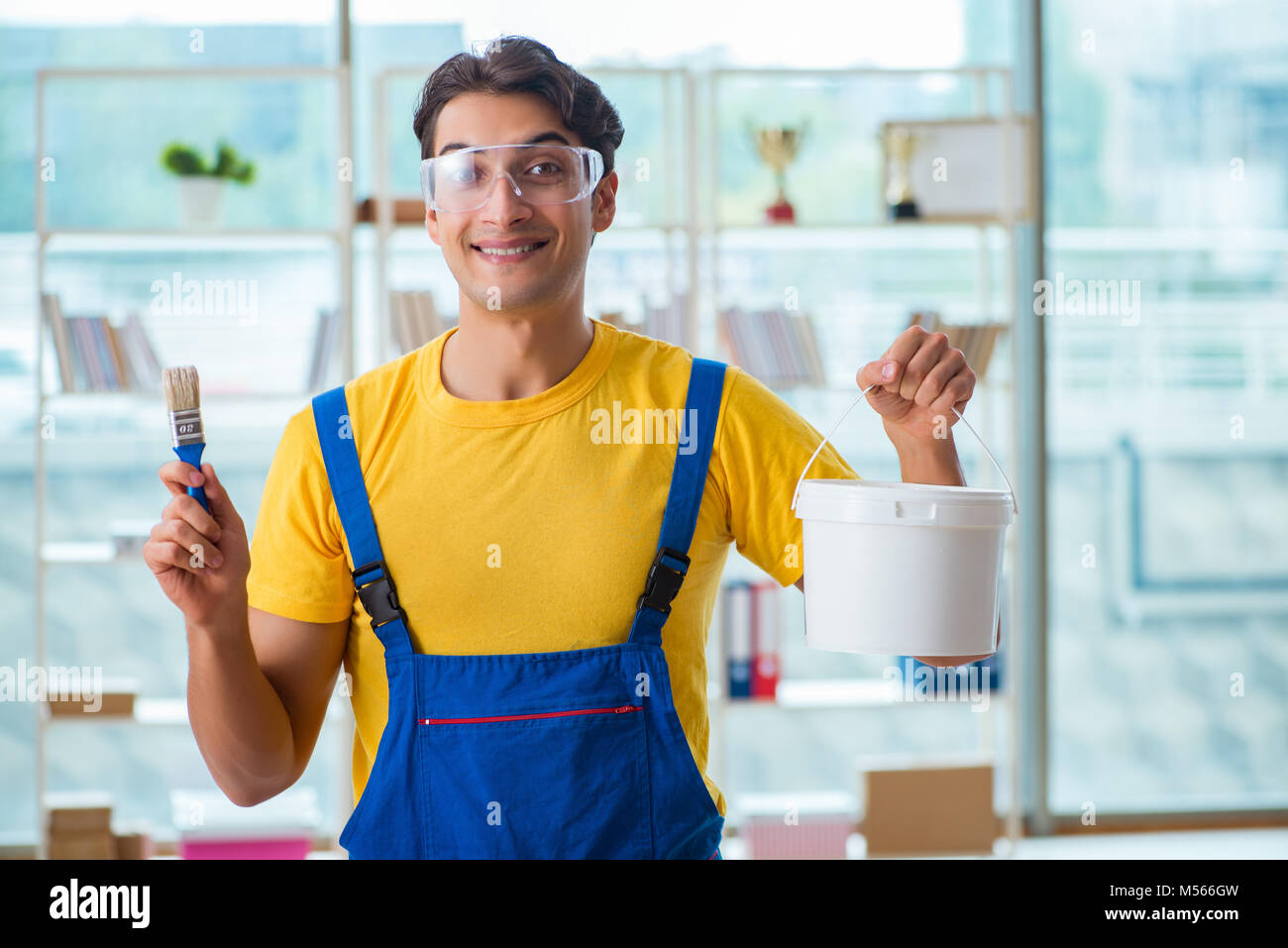 Painter with bucket of paint in Stock Photo Alamy