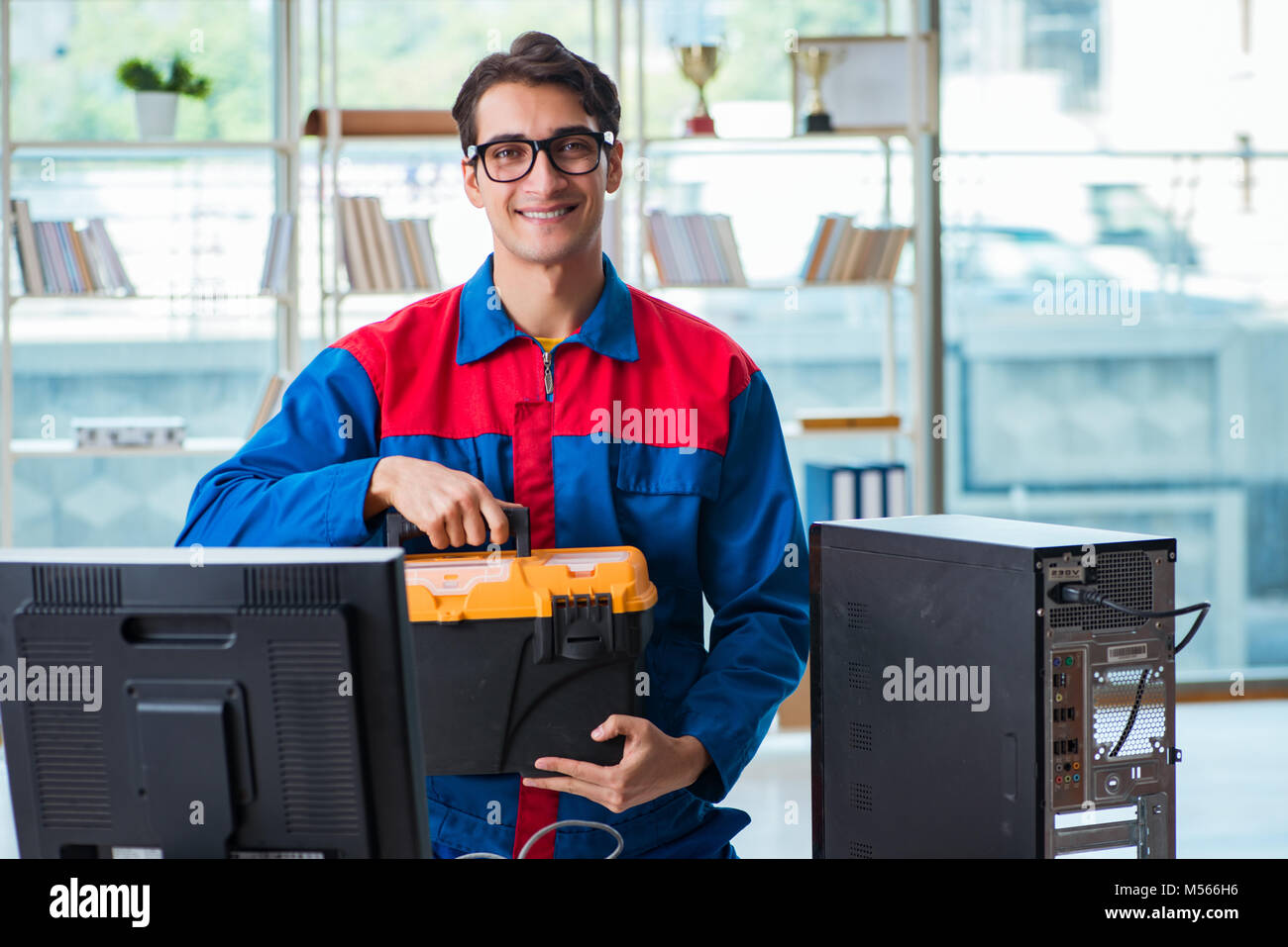 Computer Rebort Man Computer repairman working on repairing computer in IT workshop Stock ...