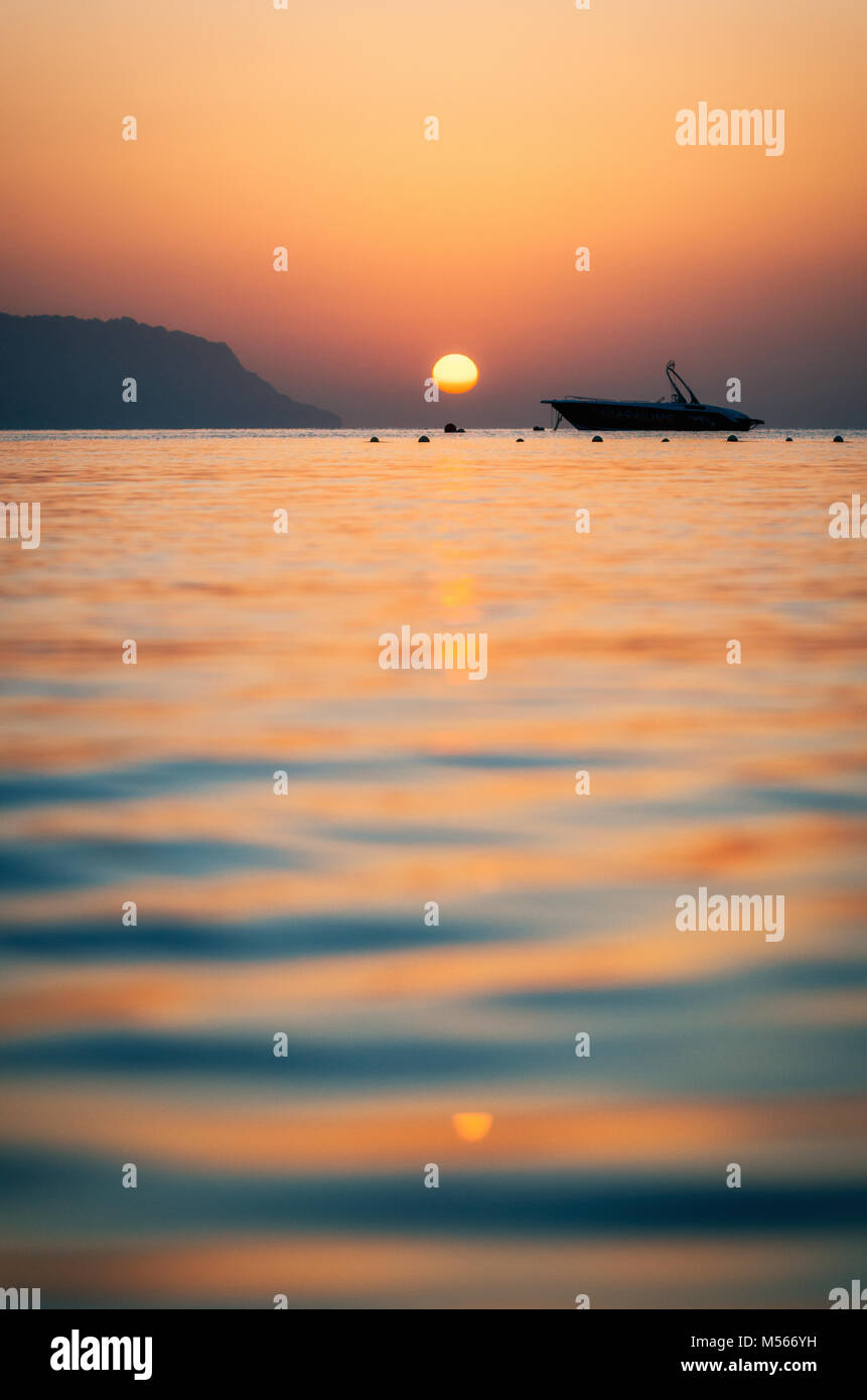 Sunset over boat on sea hi-res stock photography and images - Alamy