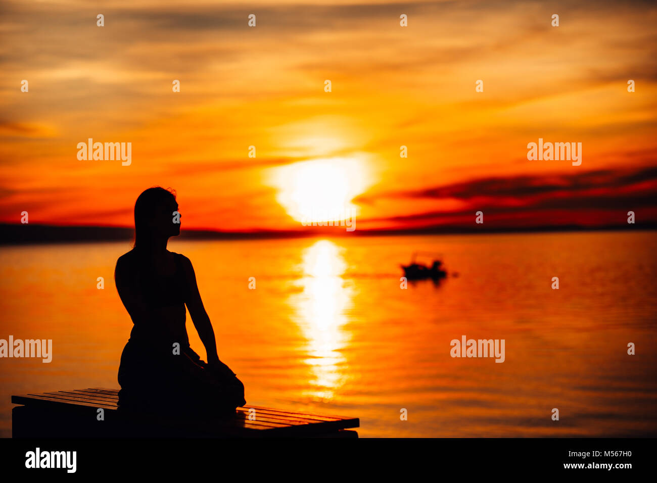 Carefree calm woman meditating in nature.Finding inner peace.Yoga practice.Spiritual healing lifestyle.Enjoying peace,anti-stress therapy,mindfulness  Stock Photo