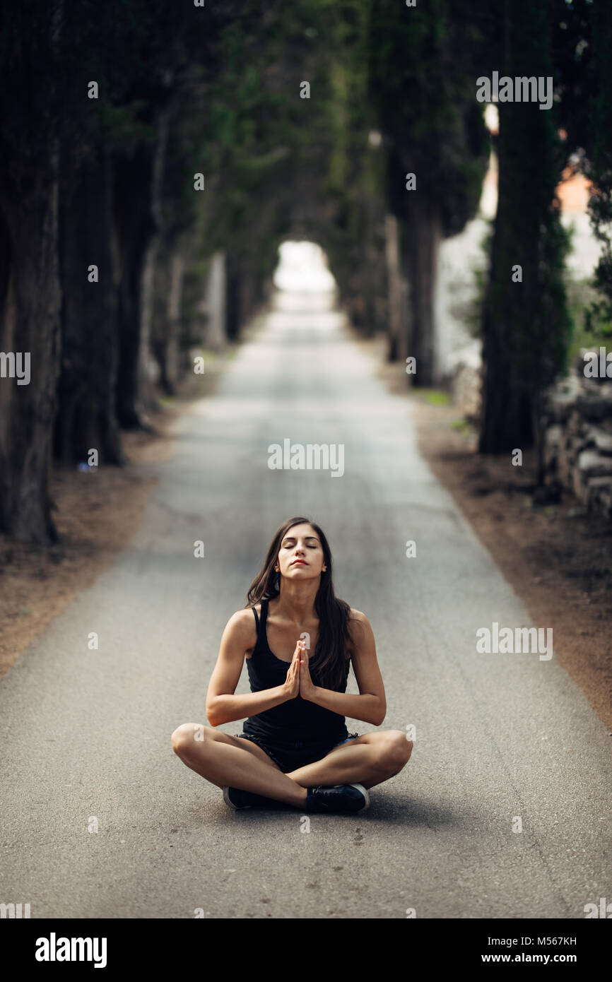 Carefree calm woman meditating in nature.Finding inner peace.Yoga practice.Spiritual healing lifestyle.Enjoying peace,anti-stress therapy,mindfulness  Stock Photo