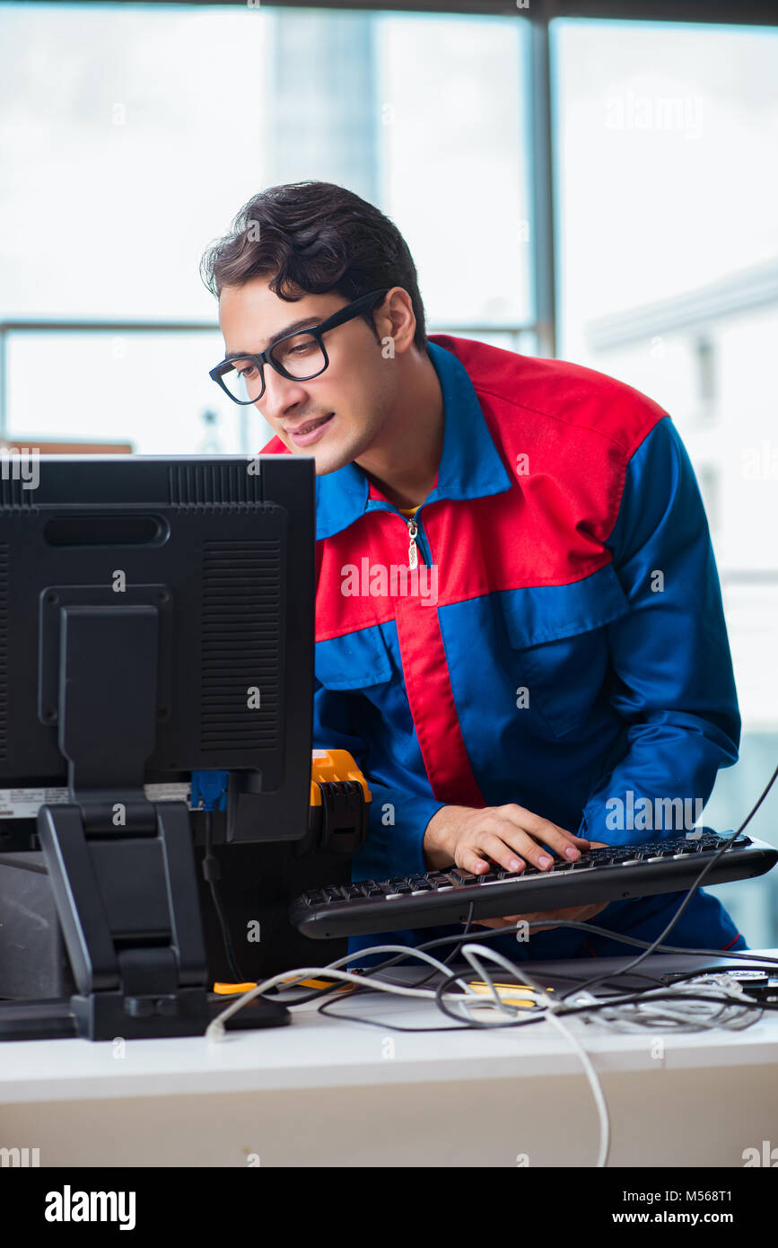 Computer Rebort Man Computer repairman working on repairing computer in IT workshop Stock ...