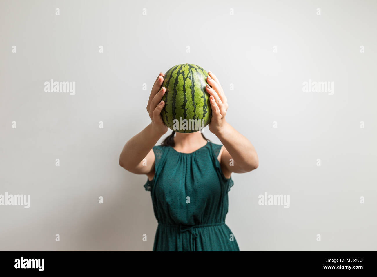Unrecognizable girl holds watermelon over her head Stock Photo Alamy