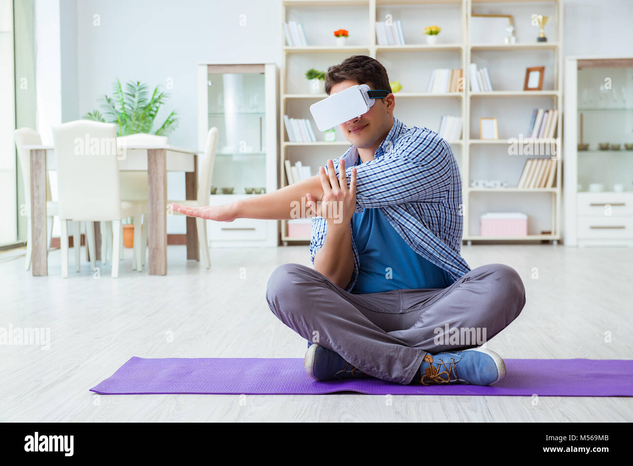 Man wearing virtual reality VR glasses doing sports at home Stock Photo ...