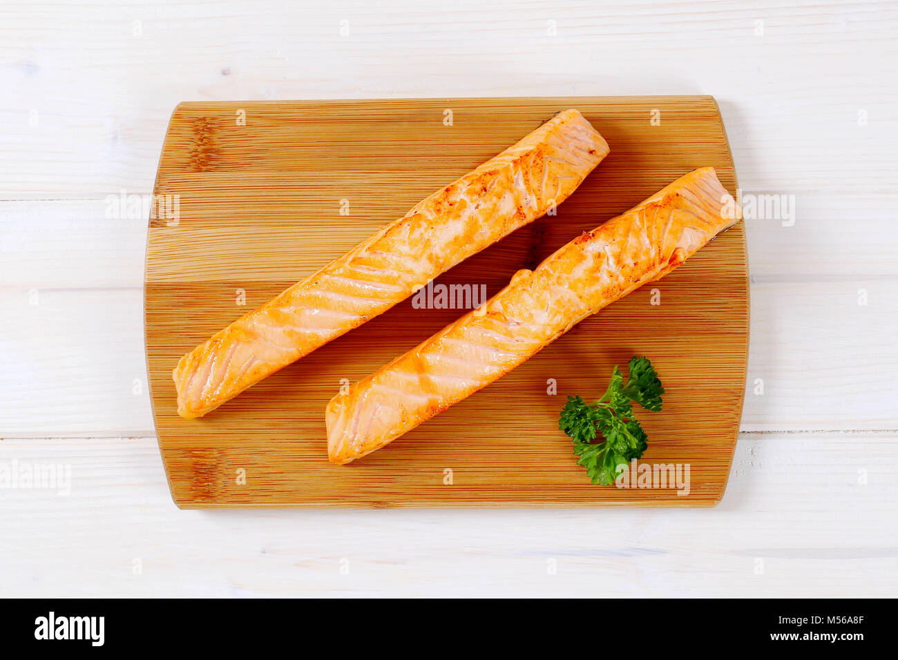 roasted salmon fillets on wooden cutting board Stock Photo - Alamy