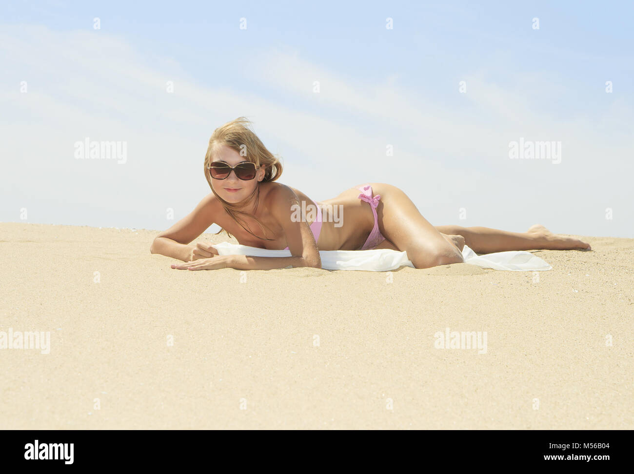 Tanned young female relaxing on the beach Stock Photo