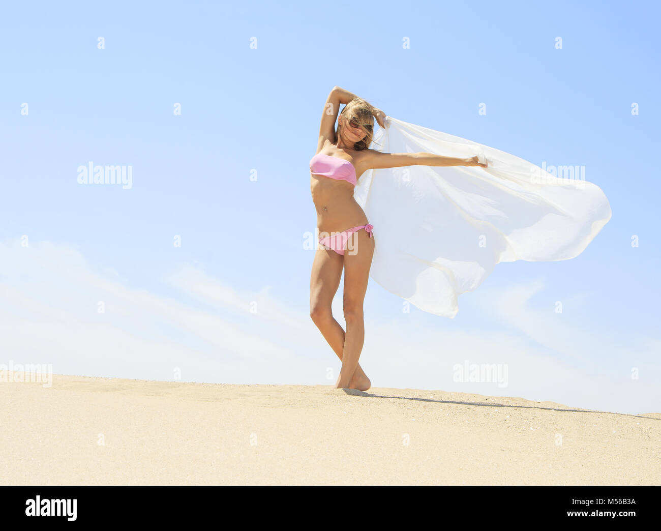 Tanned young female relaxing on the beach Stock Photo