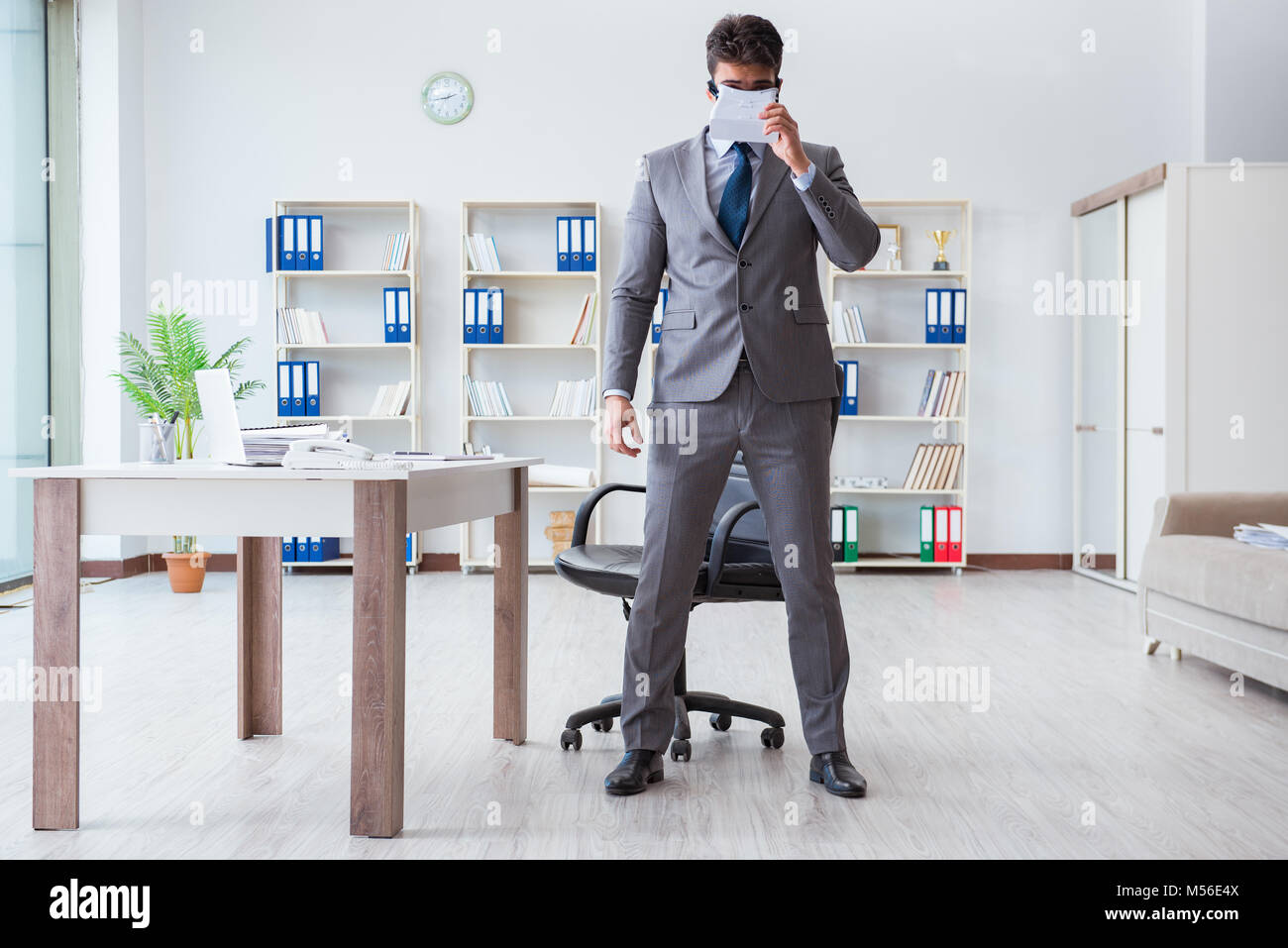 Businessman exercising in office wearing VR glasses Stock Photo - Alamy
