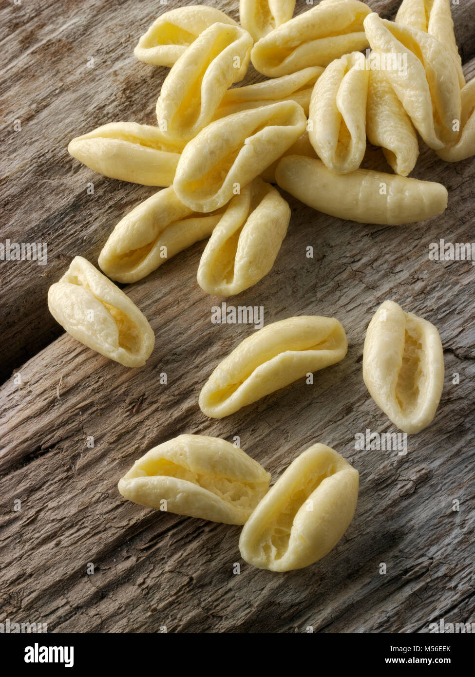 Traditional dried Cavatelli Pugleisi close up in a rustic setting on a wood background Stock Photo
