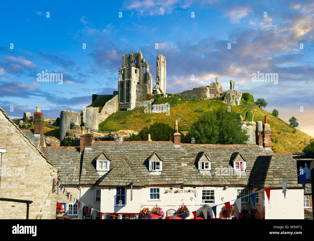 Medieval Corfe castle keep & battlements at sunrise, built in 1086 by William the Conqueror, Dorset England Stock Photo