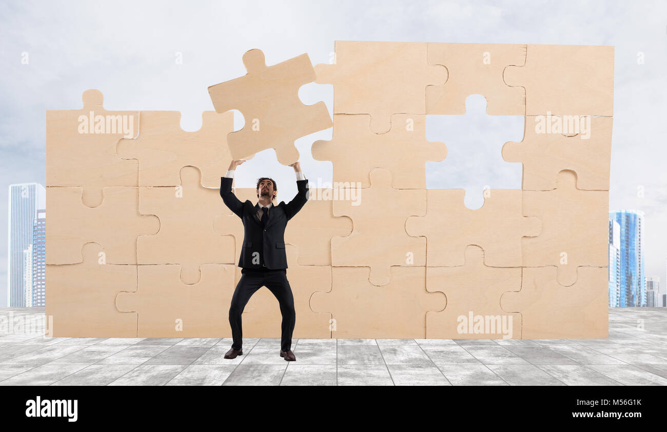 Businessman with a piece of puzzle. Build the business concept Stock Photo