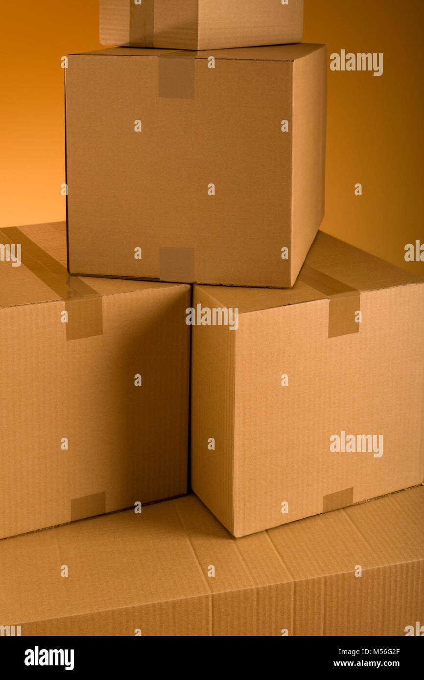 Boxes in an empty room representing concept of home moving Stock Photo