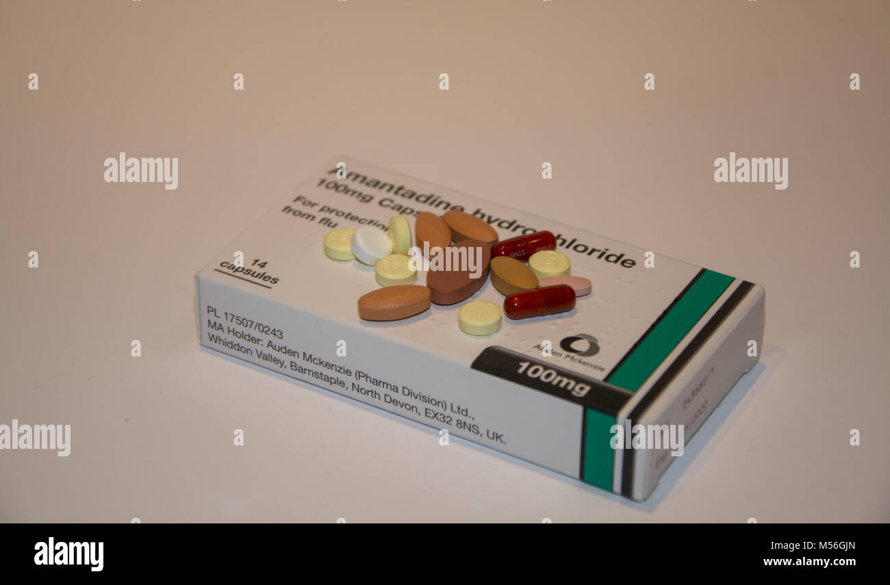 Medication used to treat Parkinson's disease on top of a box of other tablets Stock Photo