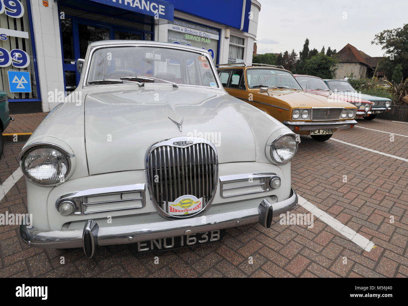 Meeting of classic Hillman and Singer Rootes Group cars at the old Maidstone factory, the art deco building is now a Peugeot car dealership Stock Photo