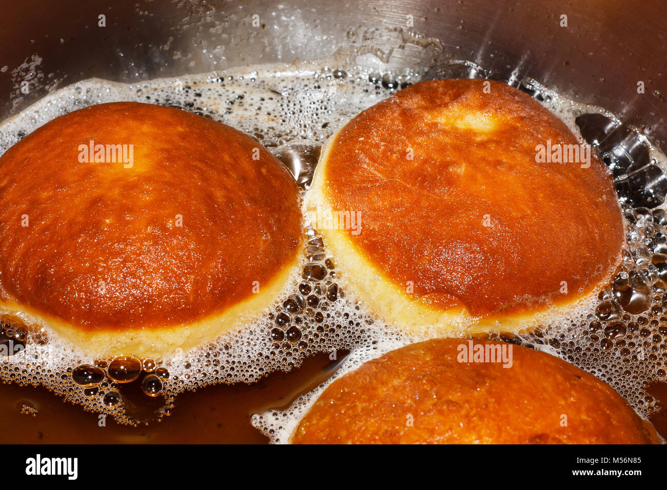 Traditional donuts frying in deep fat Stock Photo Alamy