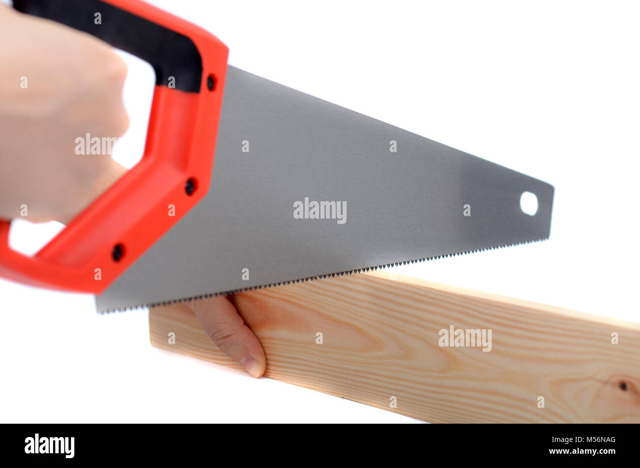 Cutting the board with a handheld saw without protective gloves,  the concept of an injury at work. Stock Photo
