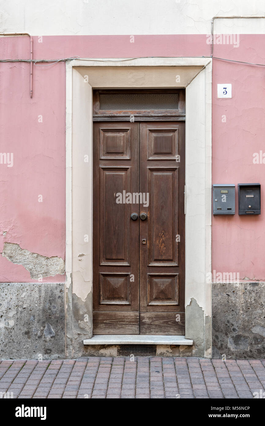 Door and pink wall of a Varzi building, Oltrepò pavese, province of Pavia,  Lombardy, northern Italy Stock Photo - Alamy
