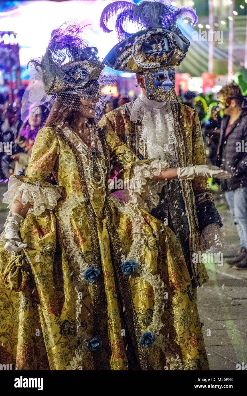Man and woman wearing a yellow medieval costume during the Carnival of Venice 2018. Venice, Italy. February 2018 Stock Photo