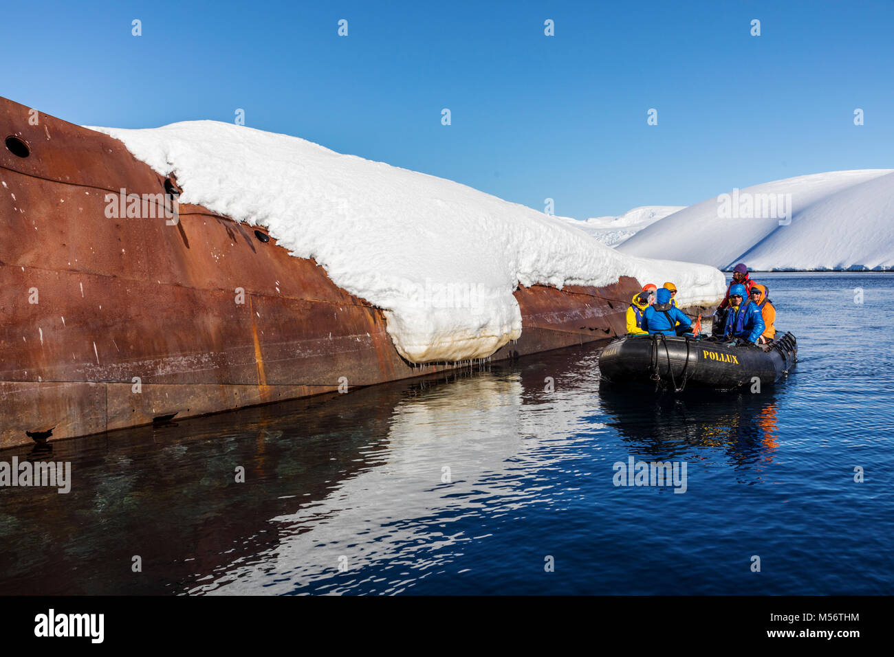 Tourists in Zodiac boat visit Norweigan whaling shipwreck; Gouvenoren; Enterprise Island; Antarctica Stock Photo