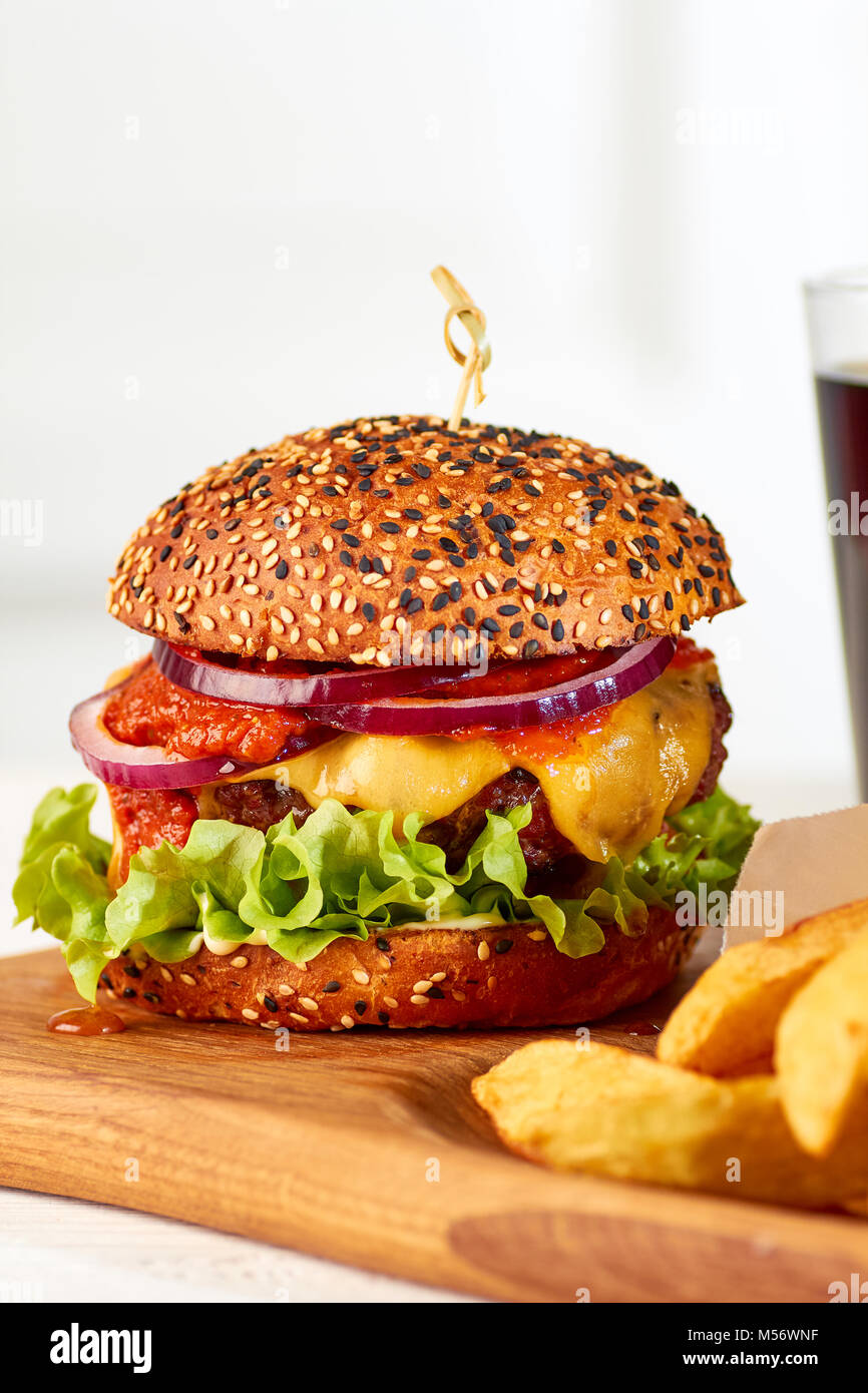 Classic cheeseburger on wooden board Stock Photo