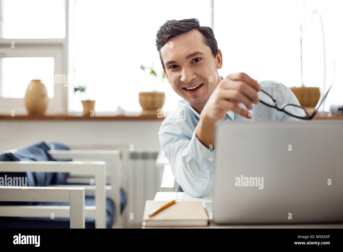 Happy employee holding his glasses Stock Photo Alamy