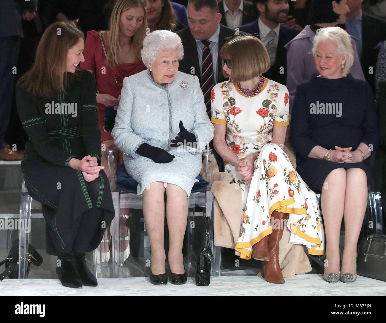 Queen Elizabeth II sits with Anna Wintour (second right) and Caroline Rush (left), chief executive of the British Fashion Council (BFC) and royal dressmaker Angela Kelly (right), as they view Richard Quinn's runway show before presenting him with the inaugural Queen Elizabeth II Award for British Design as she visits London Fashion Week's BFC Show Space in central London. Stock Photo