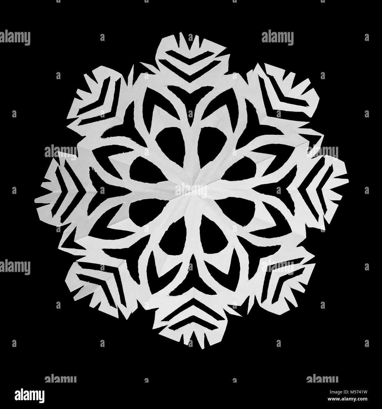 On black background lie one white snowflake, cut from paper Stock Photo ...