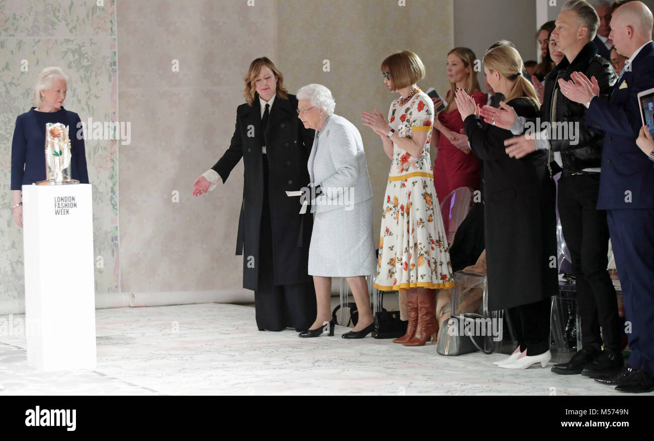 Queen Elizabeth II steps folder as she prepares to present Richard Quinn with the inaugural Queen Elizabeth II Award for British Design, after viewing his cat walk show, as she visits London Fashion Week's BFC Show Space in central London. Stock Photo