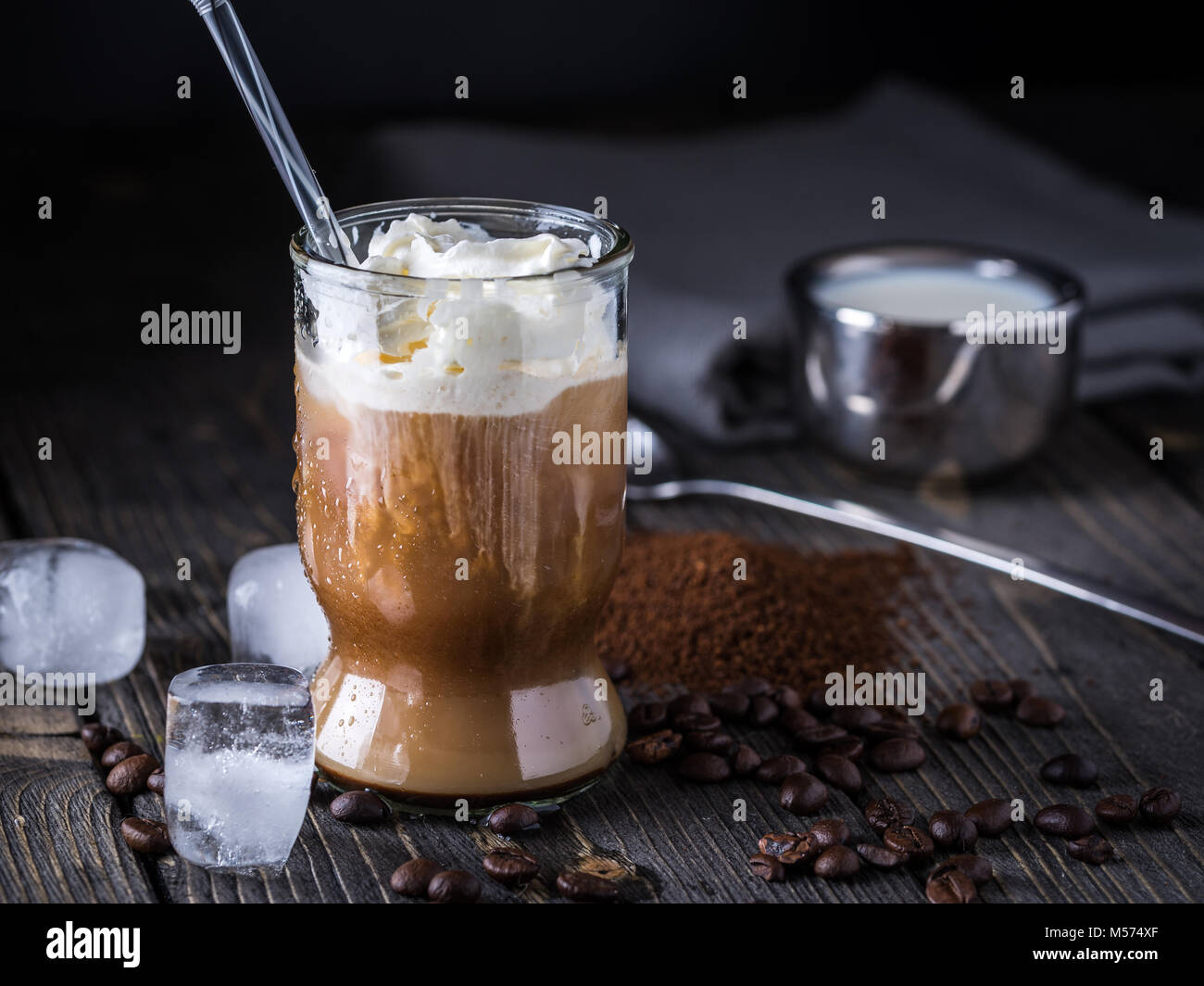 Iced coffee in a tall glass with cream poured over Stock Photo Alamy