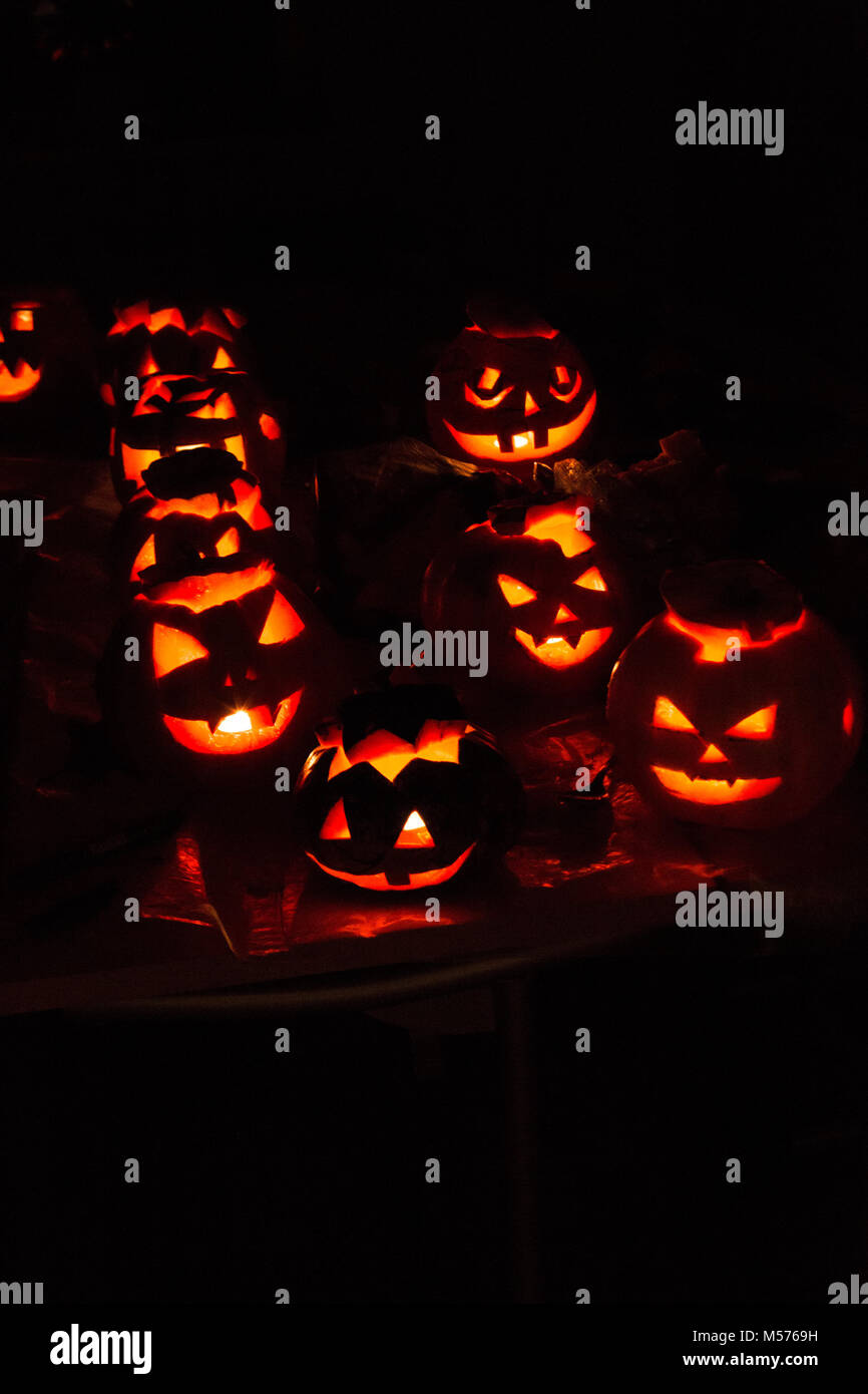 pumpkin-jack, terrible, eerie, night, black, shine, lamp, candle, red background, in the dark, carved from a pumpkin, evening, celebration, fun, laugh Stock Photo