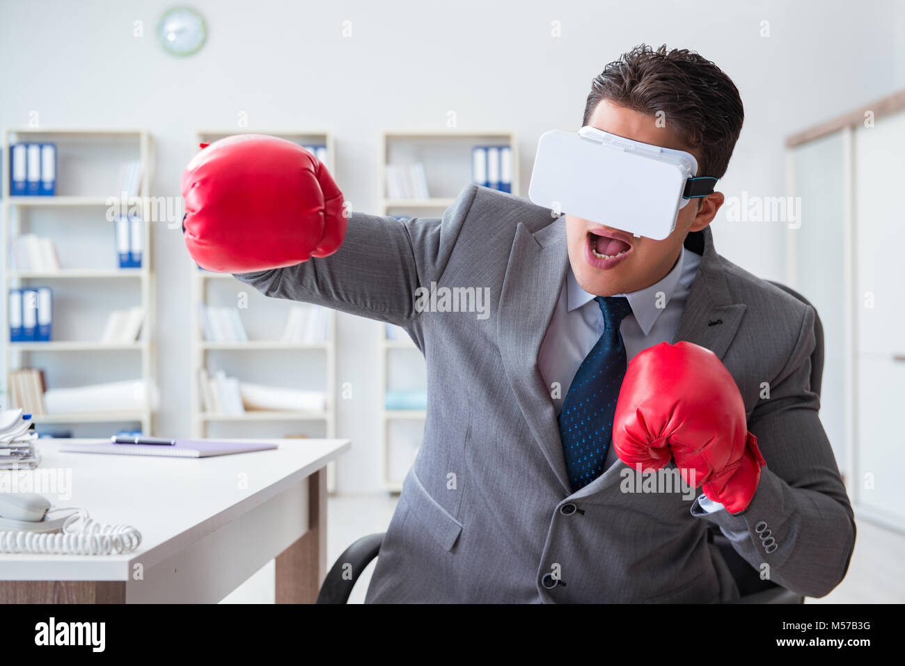 Man boxing in the office with virtual reality goggles Stock Photo Alamy