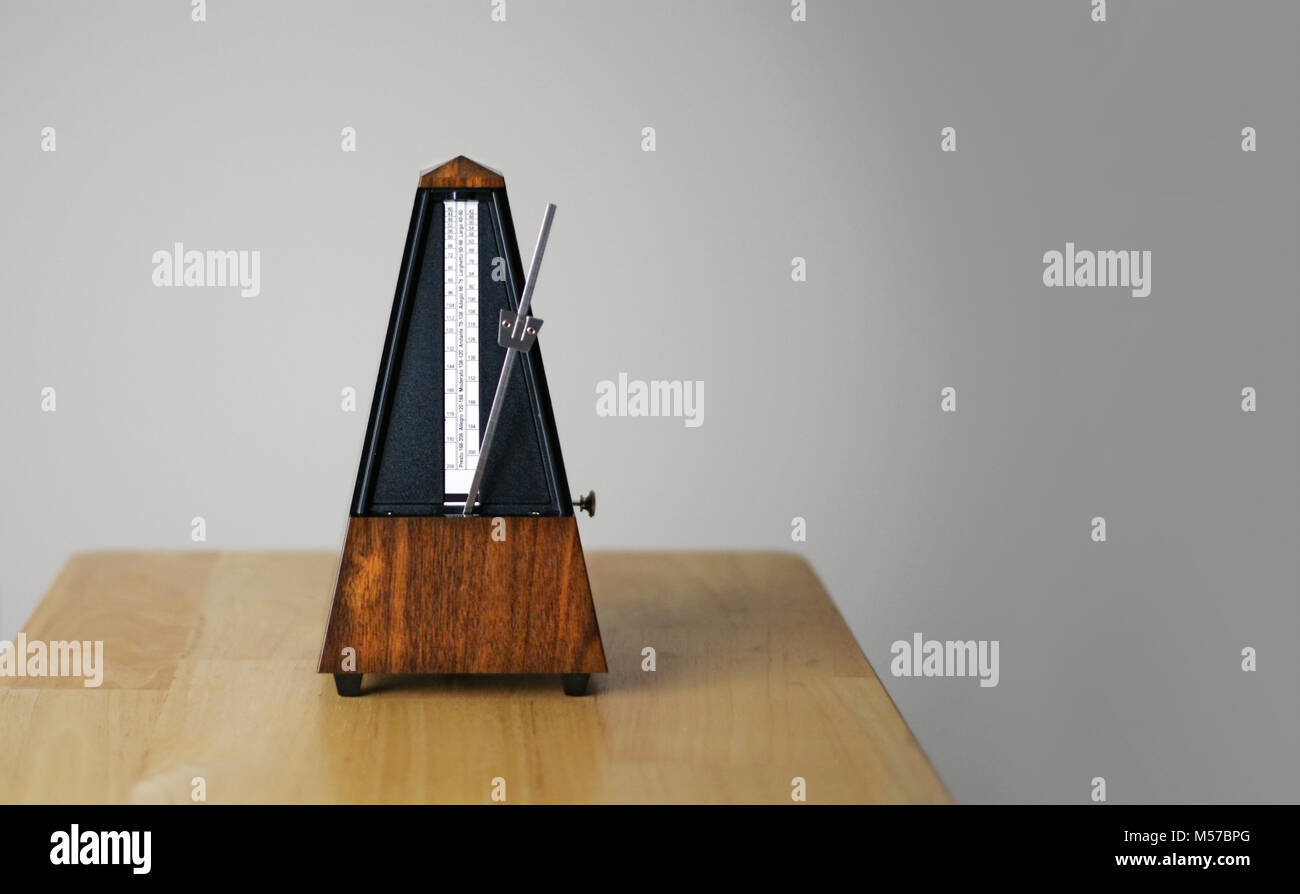 Metronome in action, closeup, isolated and on a plain background