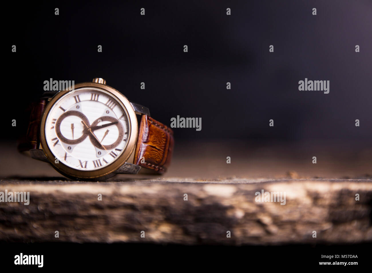 Brown  LEATHER WATCH, VINTAGE STYLE WRIST WATCH, MEN'S LEATHER WATCH on wooden background blur. Stock Photo