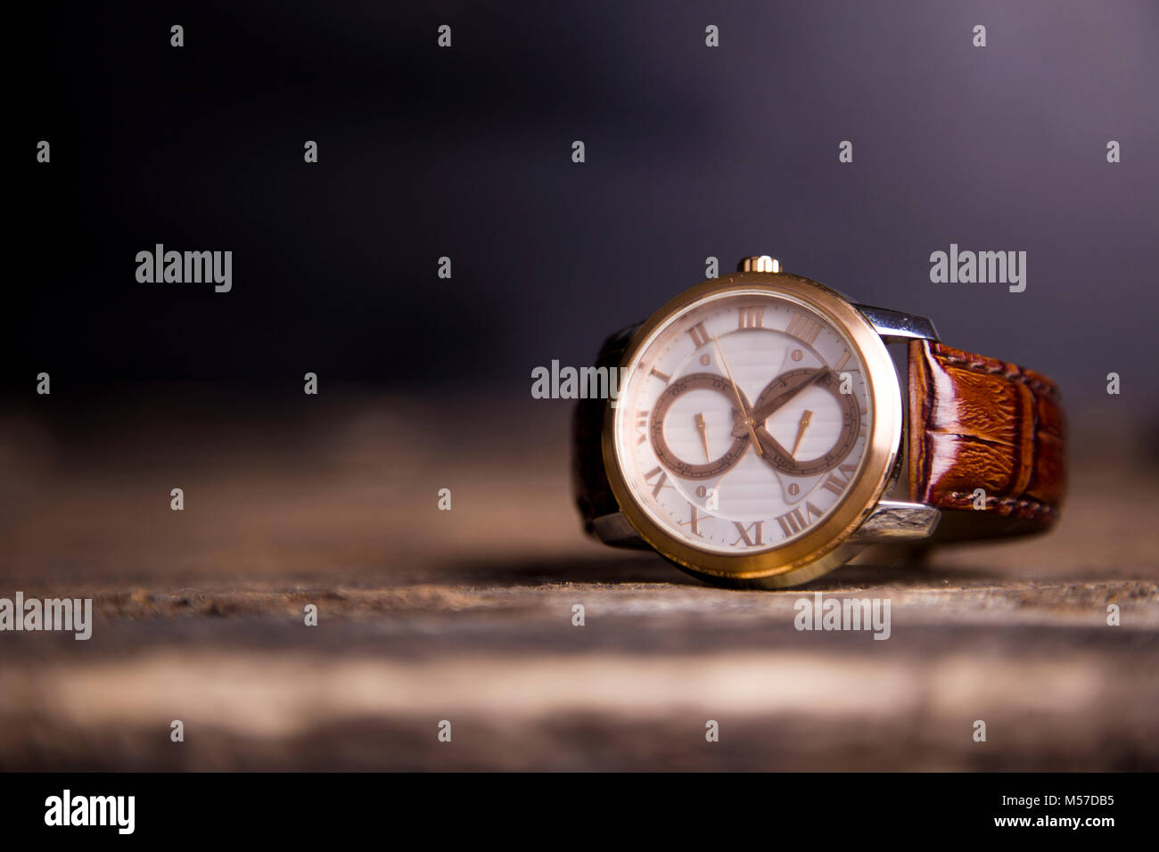 Brown  LEATHER WATCH, VINTAGE STYLE WRIST WATCH, MEN'S LEATHER WATCH on wooden background blur. Stock Photo