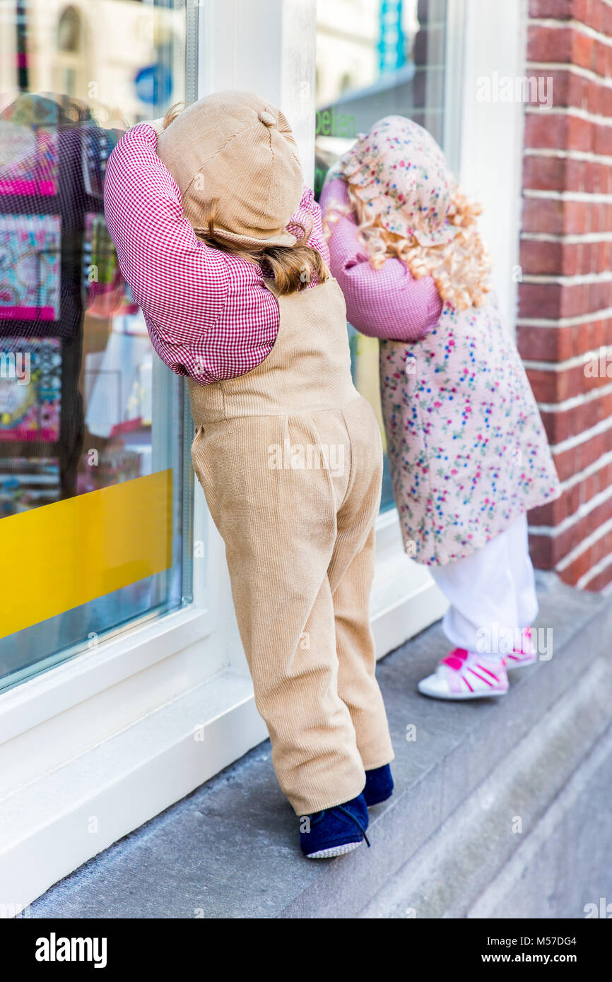 boy-and-girl-puppet-peek-through-shop-window-stock-photo-alamy