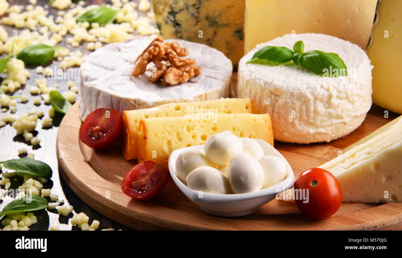 Different sorts of cheese on kitchen table Stock Photo - Alamy
