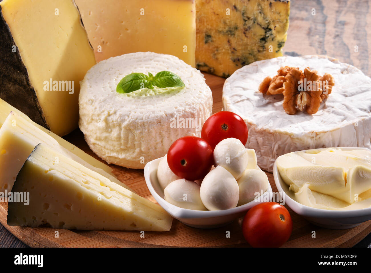 Different sorts of cheese on kitchen table Stock Photo - Alamy