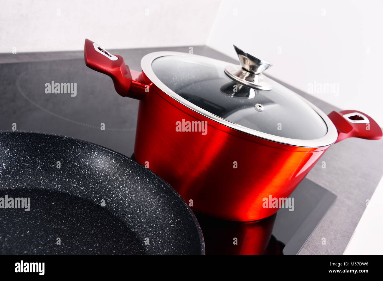 Frying pan and steel pot on modern induction cooktop Stock Photo Alamy