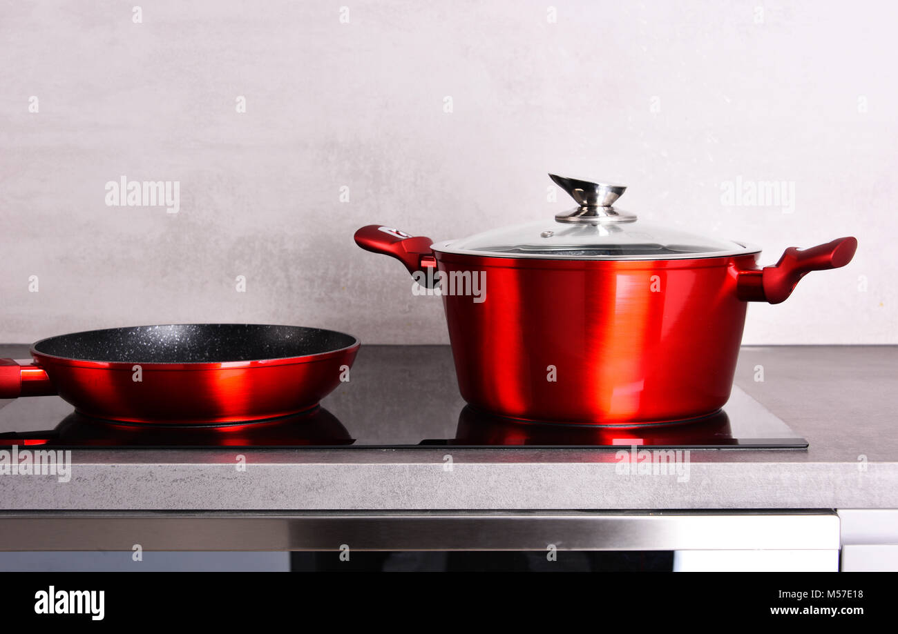 Frying pan and steel pot on modern induction cooktop Stock Photo Alamy