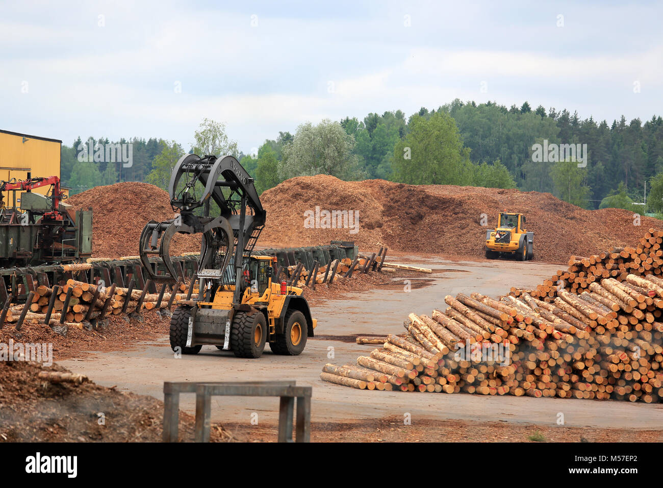 KYRO, FINLAND - JUNE 7, 2014: Volvo L180F High Lift wheel loader working at mill lumber yard.  The arm is capable of reaching a lift height of 5.8 m u Stock Photo