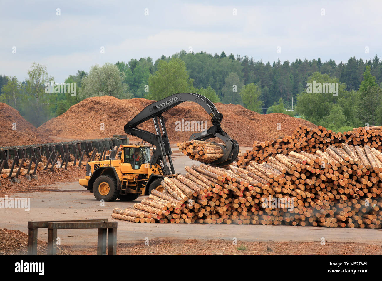 KYRO, FINLAND - JUNE 7, 2014: Volvo L180F High Lift wheel loader working at mill lumber yard.  The arm is capable of reaching a lift height of 5.8 m u Stock Photo